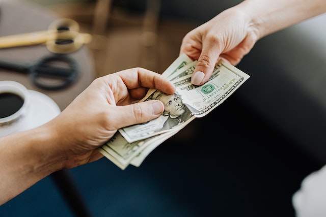 two people exchanging paper bills